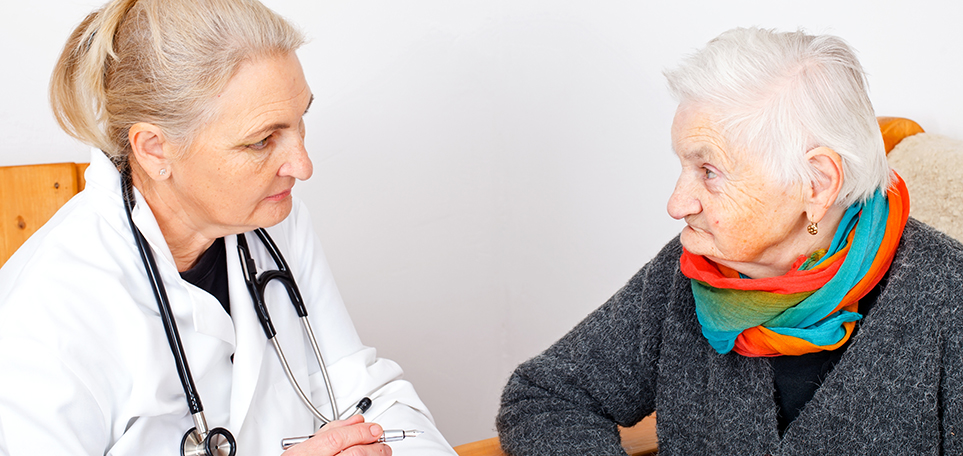 Doctor talking to older woman during medical visit