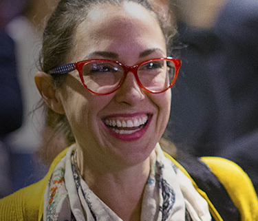 Close up of woman with red glasses laughing