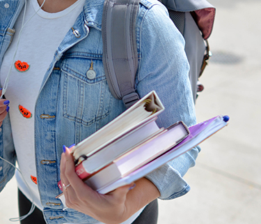 a student with books and a backpack.