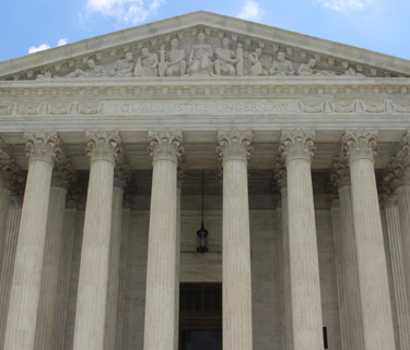 Close up of the U.S. Supreme Court, focused on the pillars, and doorway.