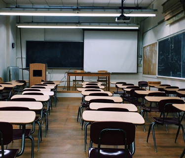 Rows of empty desks in a classroom