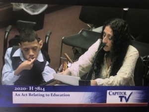 A mother and her son in a wheelchair testify in a public policy hearing. 