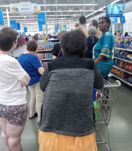 Betty Davis stands in line with a few of her clients at Walmart