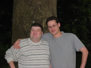 Burt and John, a man with WAGR syndrome, stand together with their arms around each other.